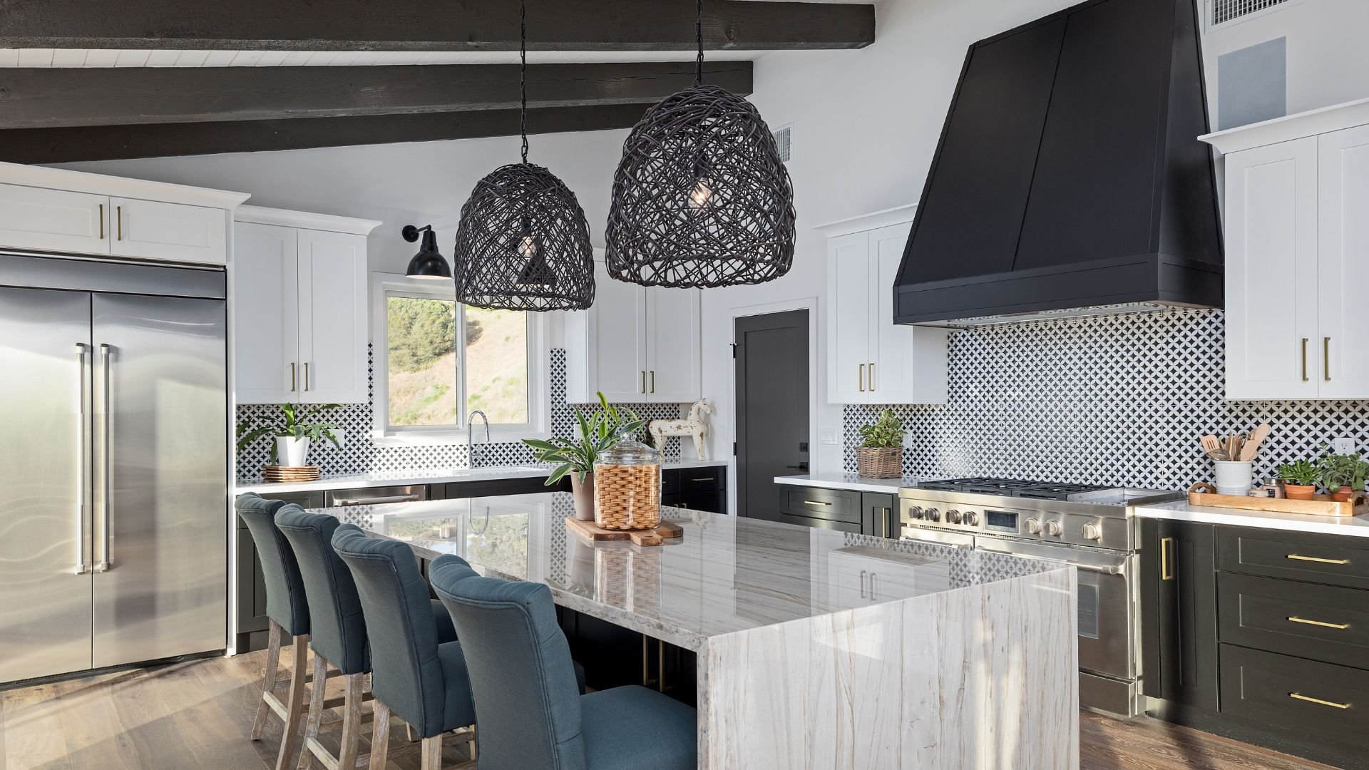 Modern kitchen with blue chairs, marble countertop, and woven pendant lights