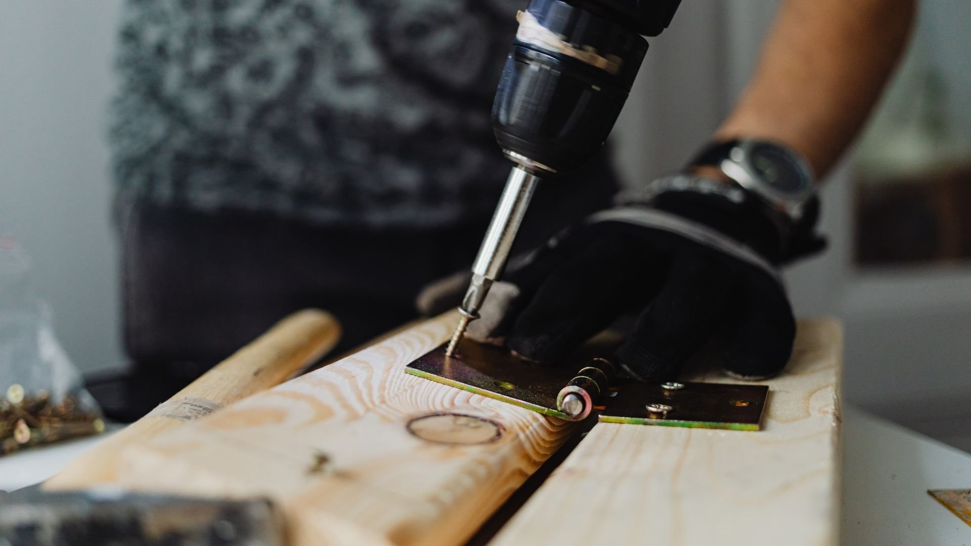 Close-up of a power drill boring into a wooden board with precision